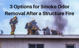 firemen on a roof with smoke