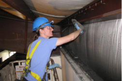 man restoring old church with fire damage